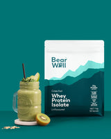 BearWell Unflavoured Whey Protein Isolate 1kg bag with glass of kiwi smoothie with the unflavoured whey in it 